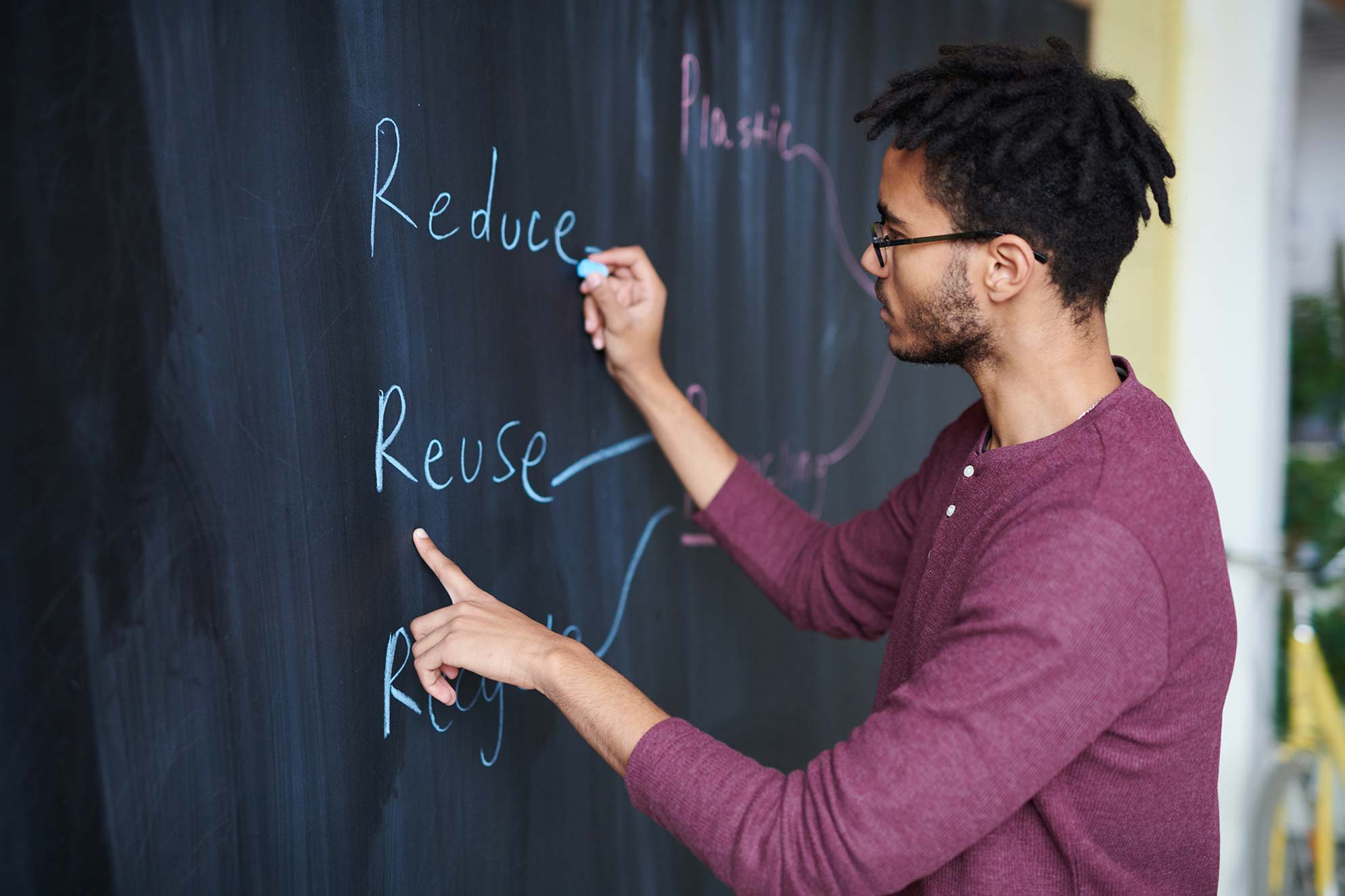 Work in progress a man writing on a chalkboard