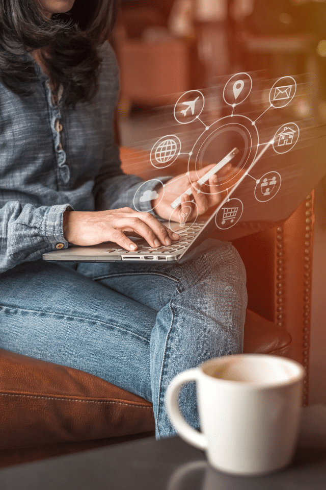 a person sitting on a chair using a laptop